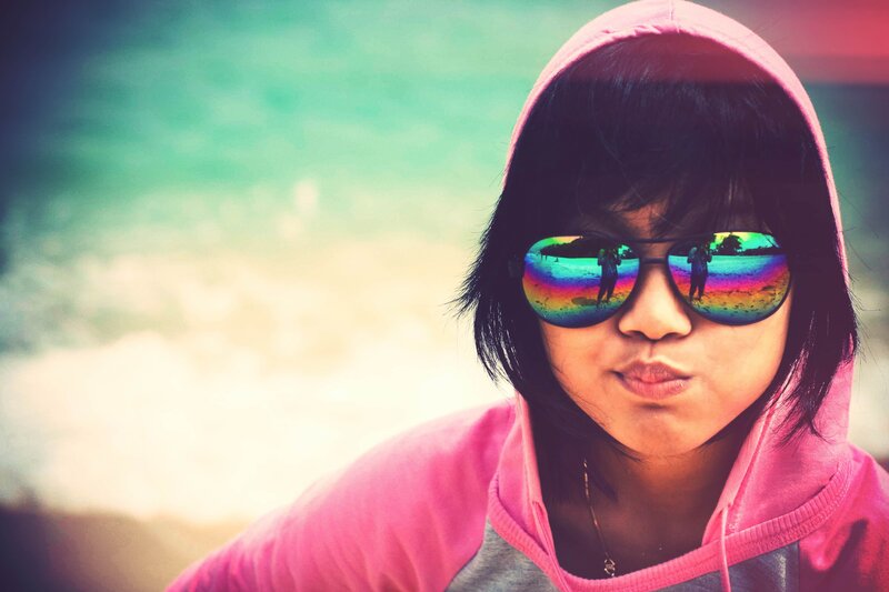 person in pink hoodie at beach