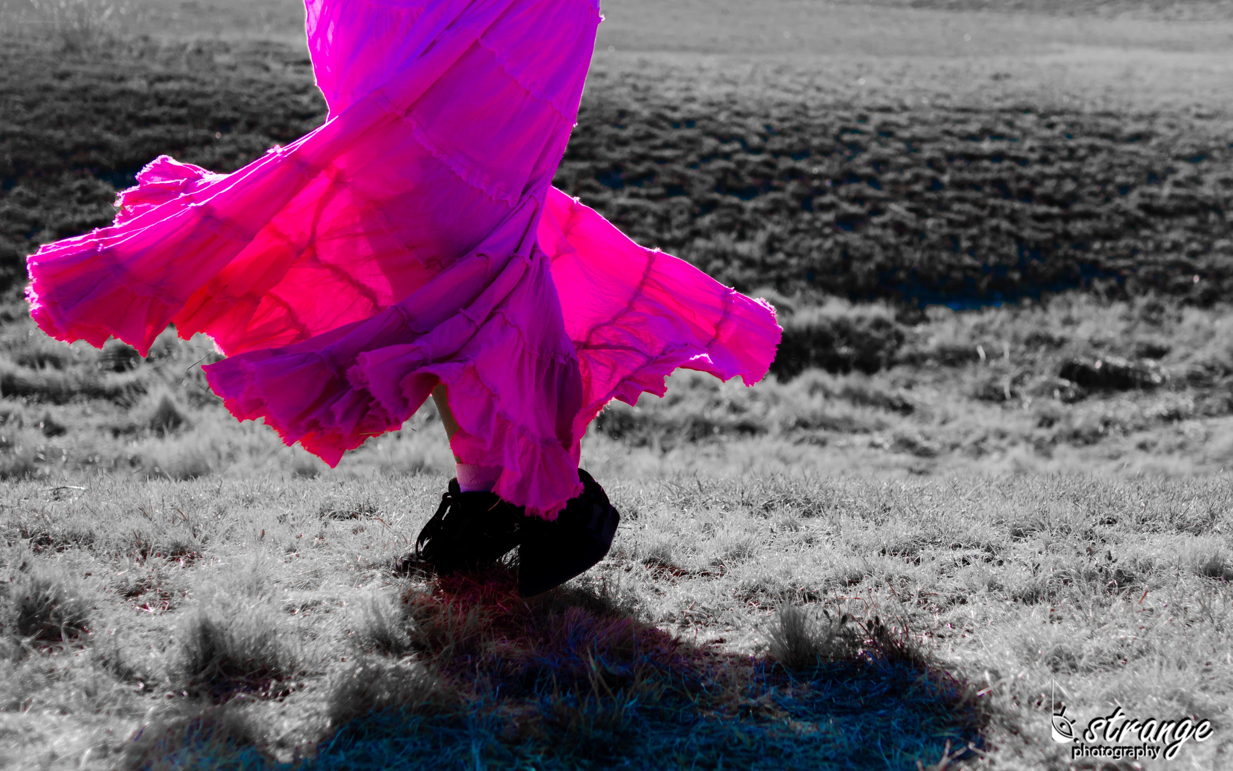 person in pink skirt walking