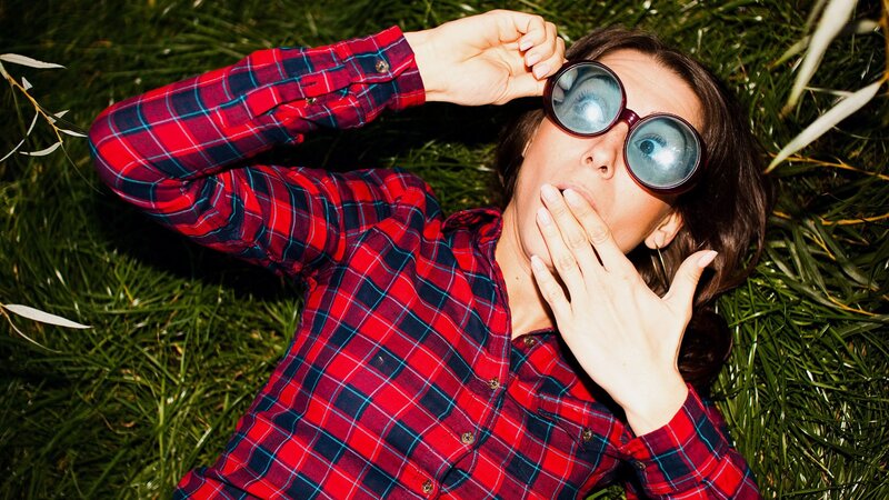 person in plaid shirt lying on grass