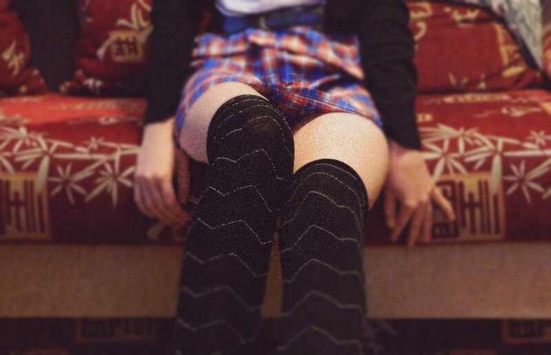 person in plaid skirt and socks
