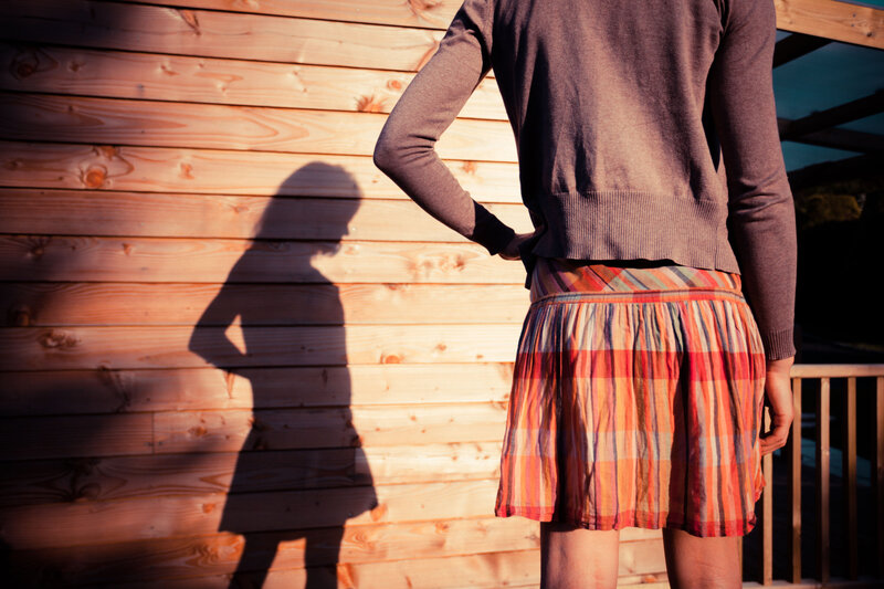 Person in Plaid Skirt — Brown