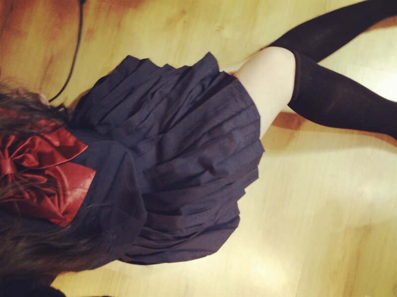 person in pleated skirt lying down
