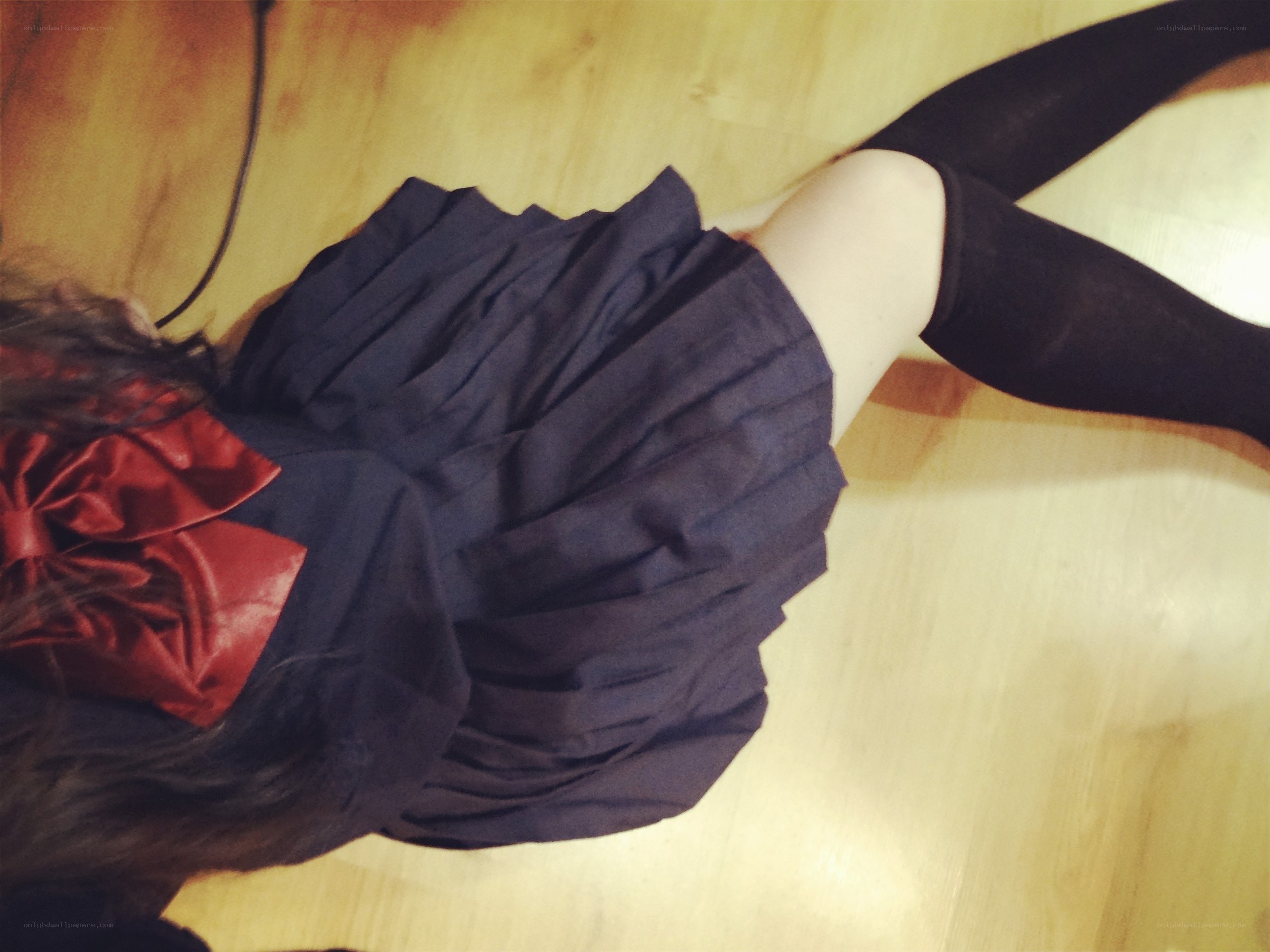 person in pleated skirt lying down
