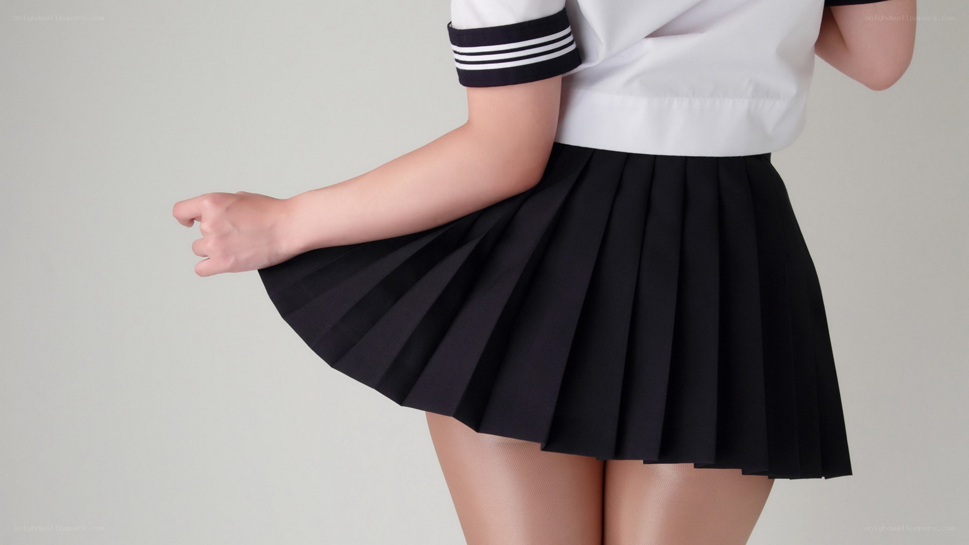 person in pleated skirt