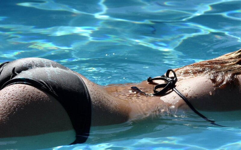 person in pool wearing swimsuit