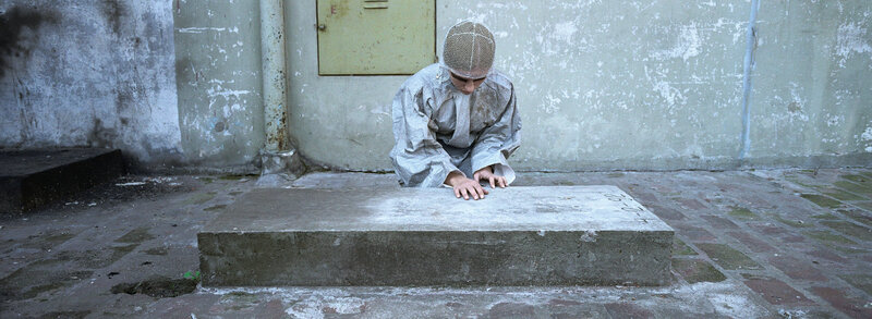 person in protective gear on concrete slab