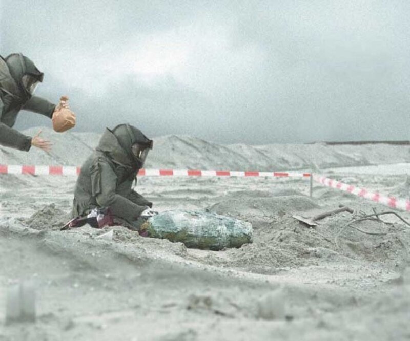 Person in protective gear with bomb