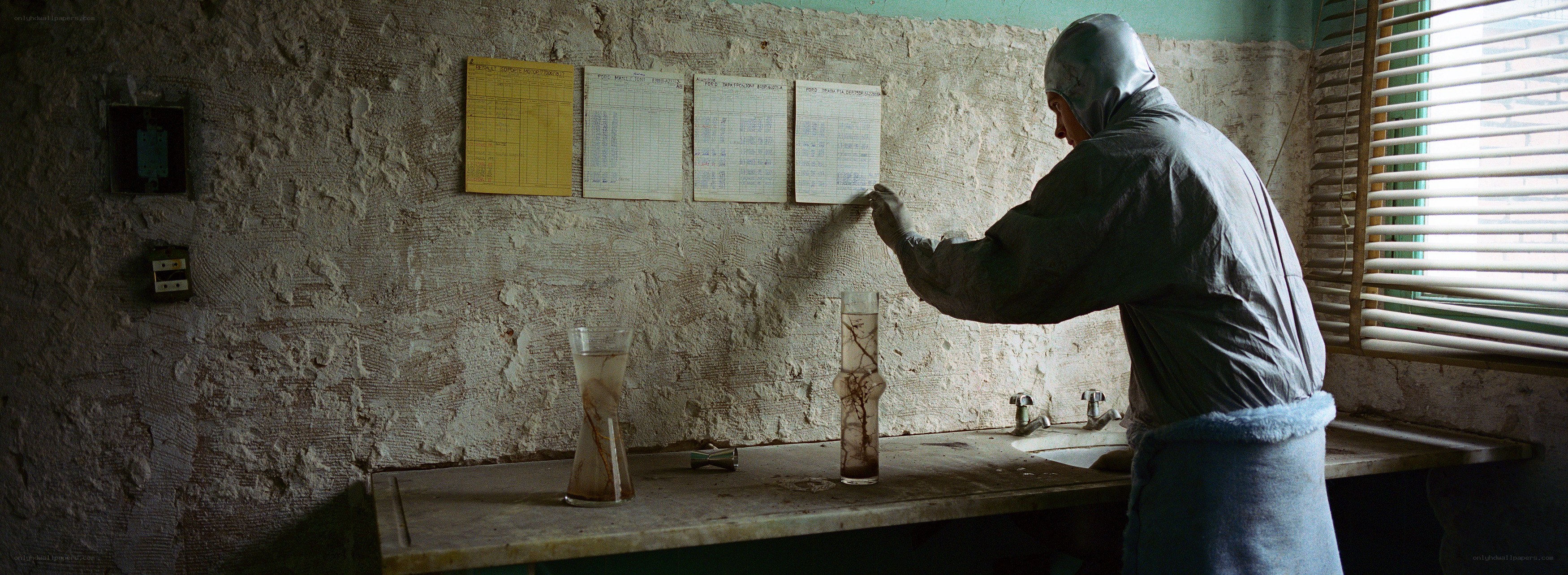 person in protective suit writing