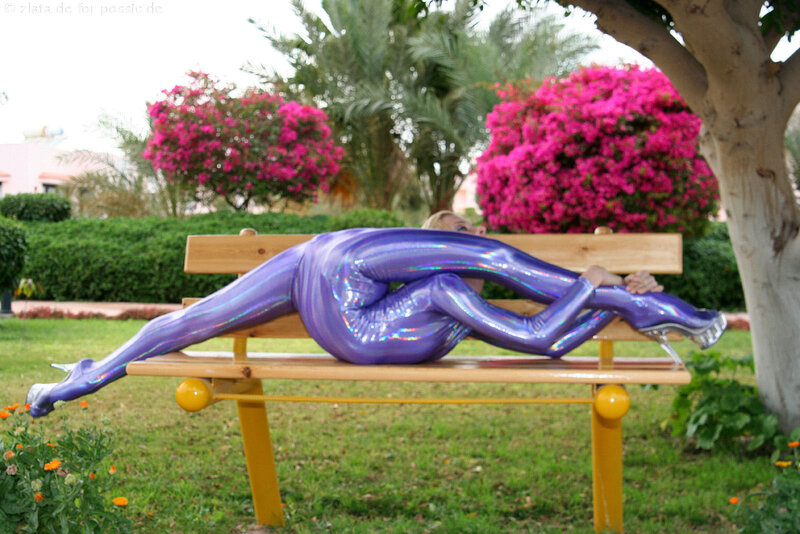 Person in purple suit on bench