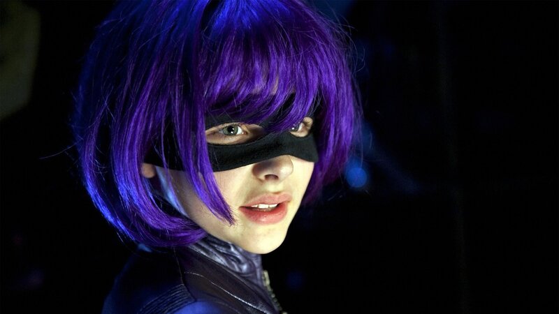 person in purple wig and mask