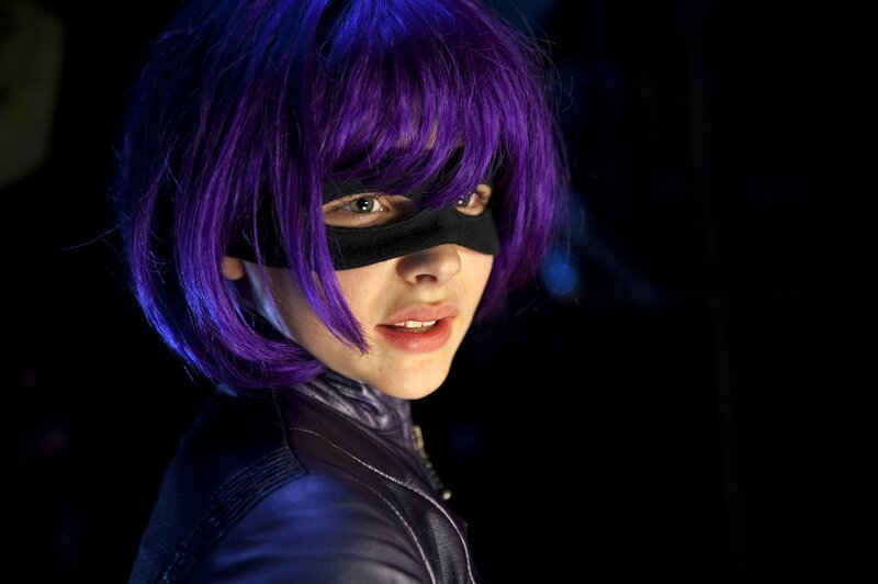person in purple wig and mask