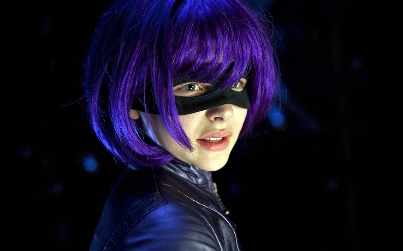 person in purple wig and mask