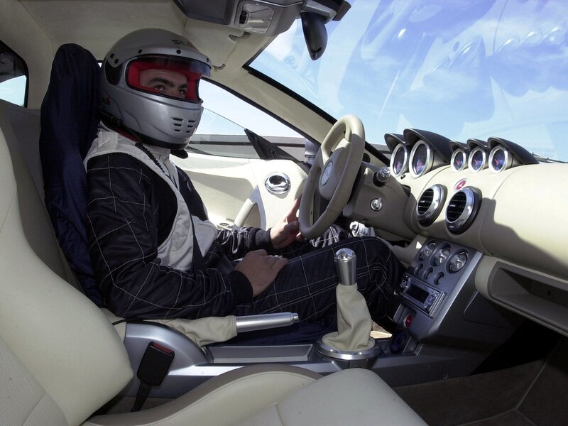 Person in racing helmet inside car
