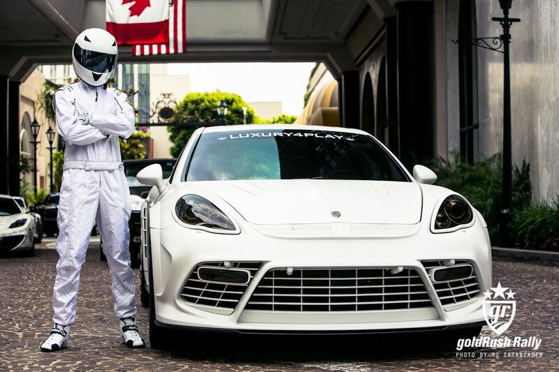 person in racing suit with white car
