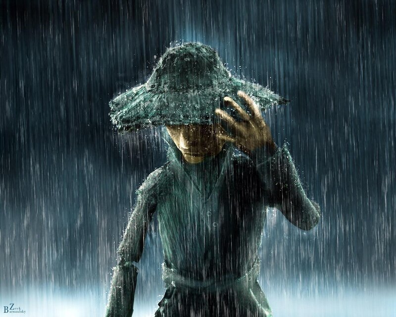 person in rain with hat