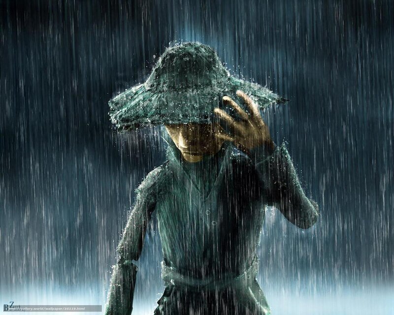 person in rain with hat