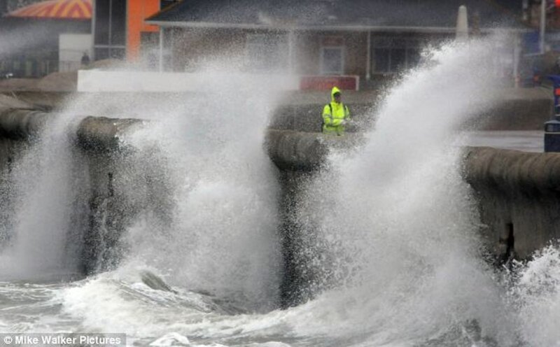 Person in Raincoat on Pier