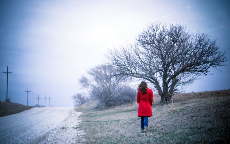 Person in Red Coat — Somber