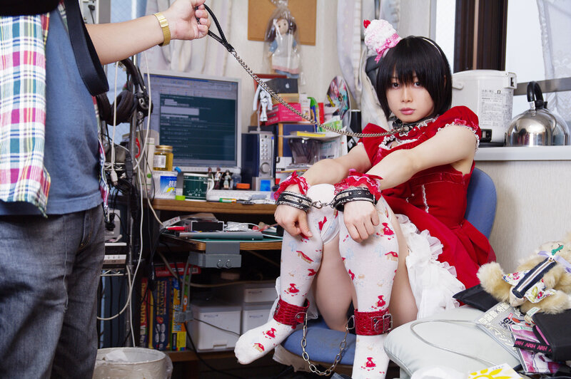 person in red dress with restraints