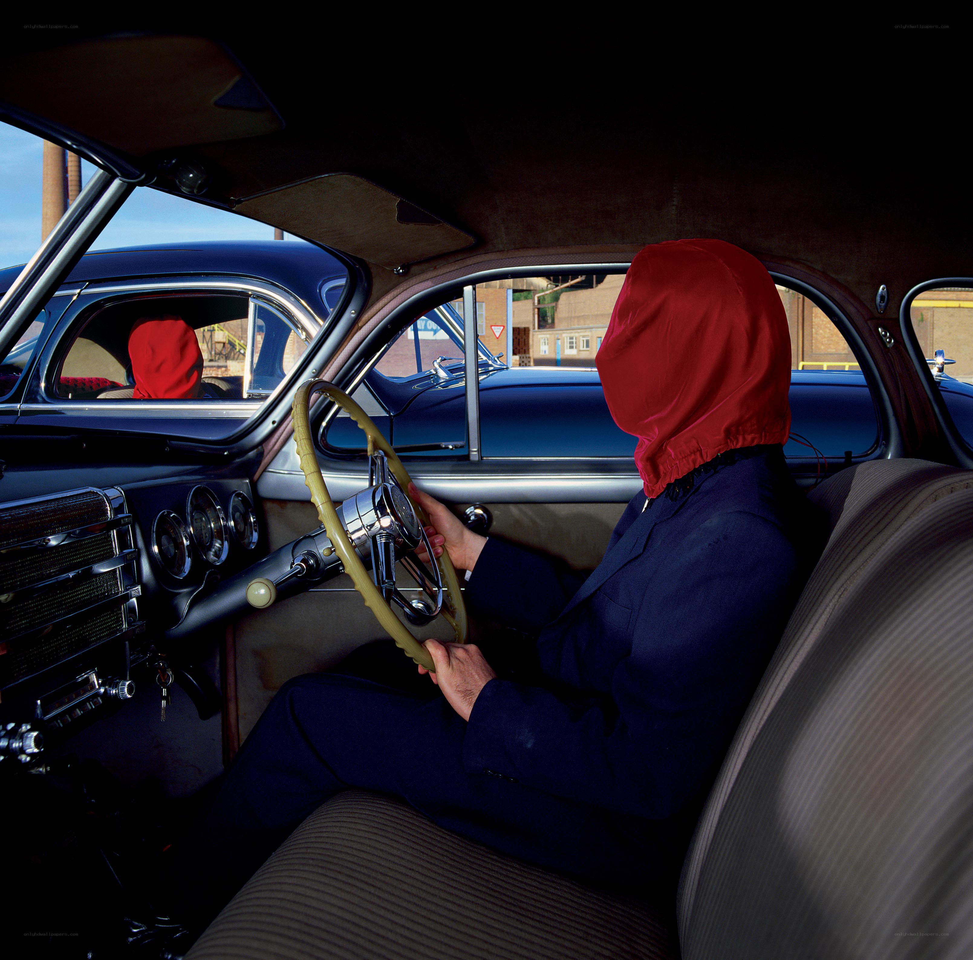 person in red hood driving car