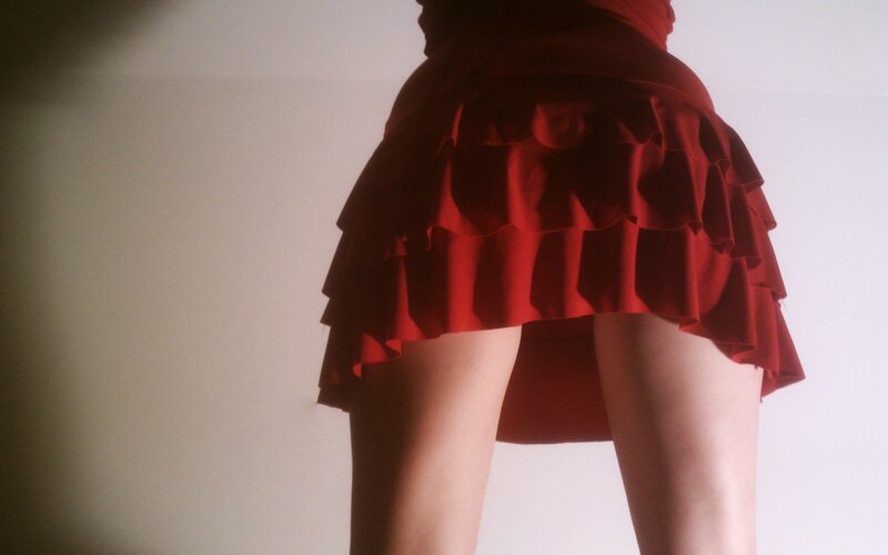 person in red ruffled skirt
