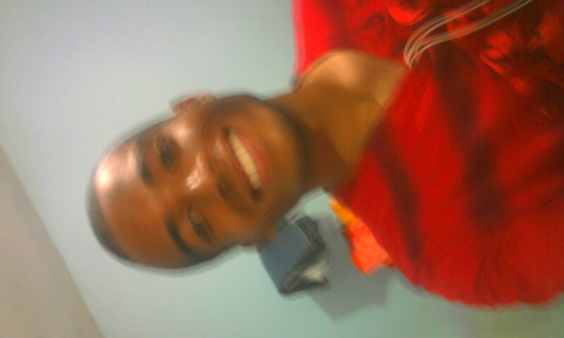 person in red shirt smiling
