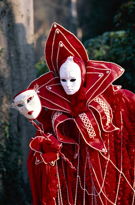 Person in red Venetian costume