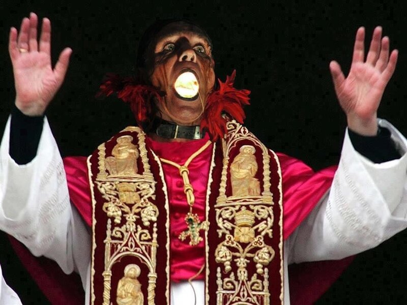 person in religious costume with mask