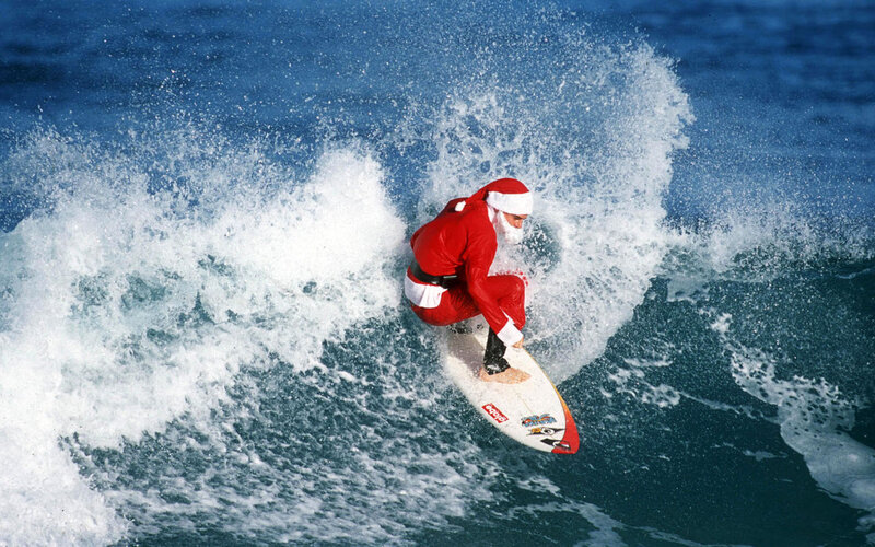 Person in Santa Suit Surfing