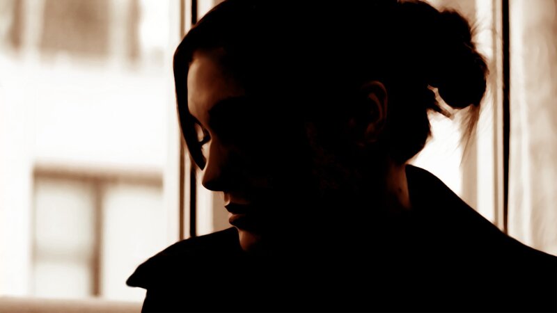 person in silhouette by window