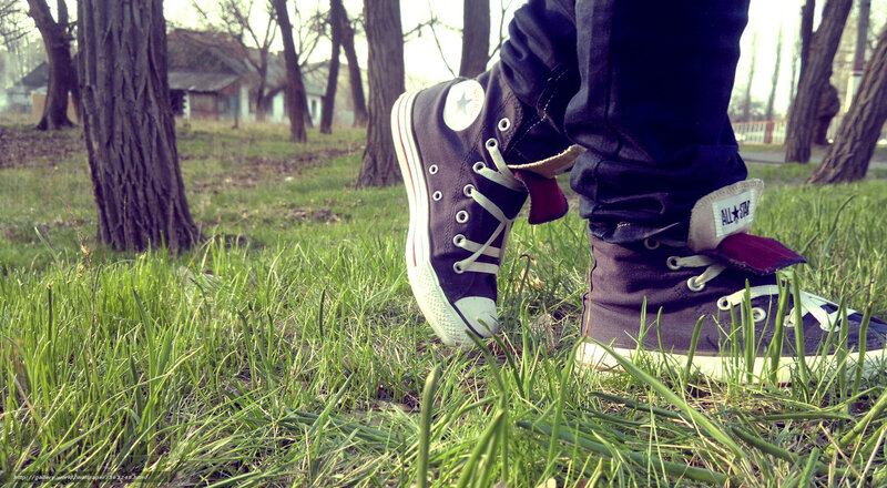 person in sneakers on grass
