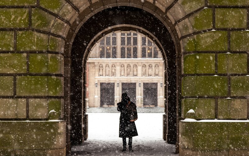 Person in snowstorm at archway