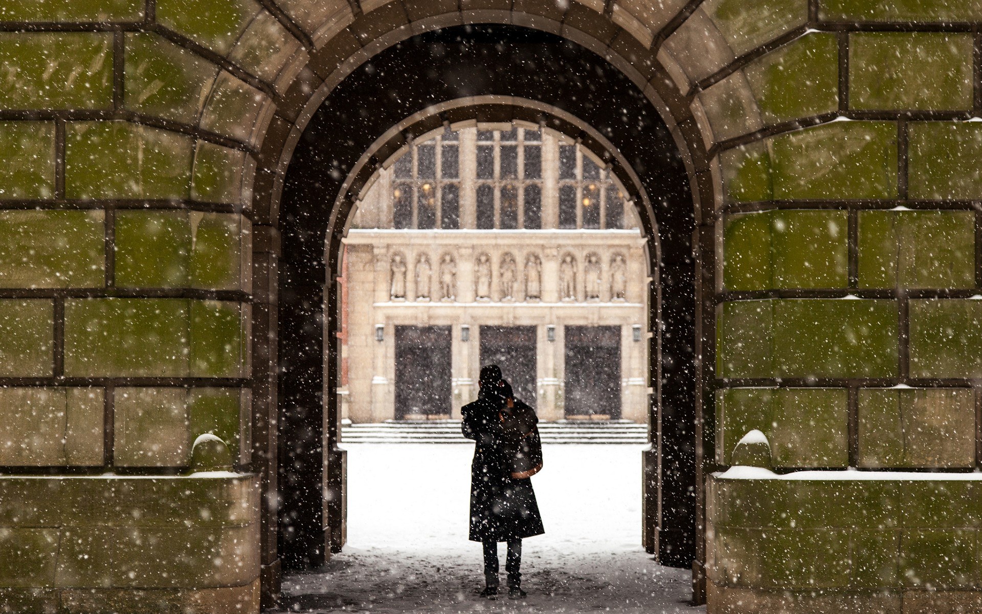 Person in snowstorm at archway