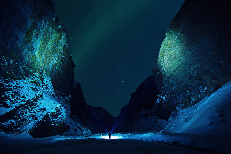 Person in snowy canyon at night