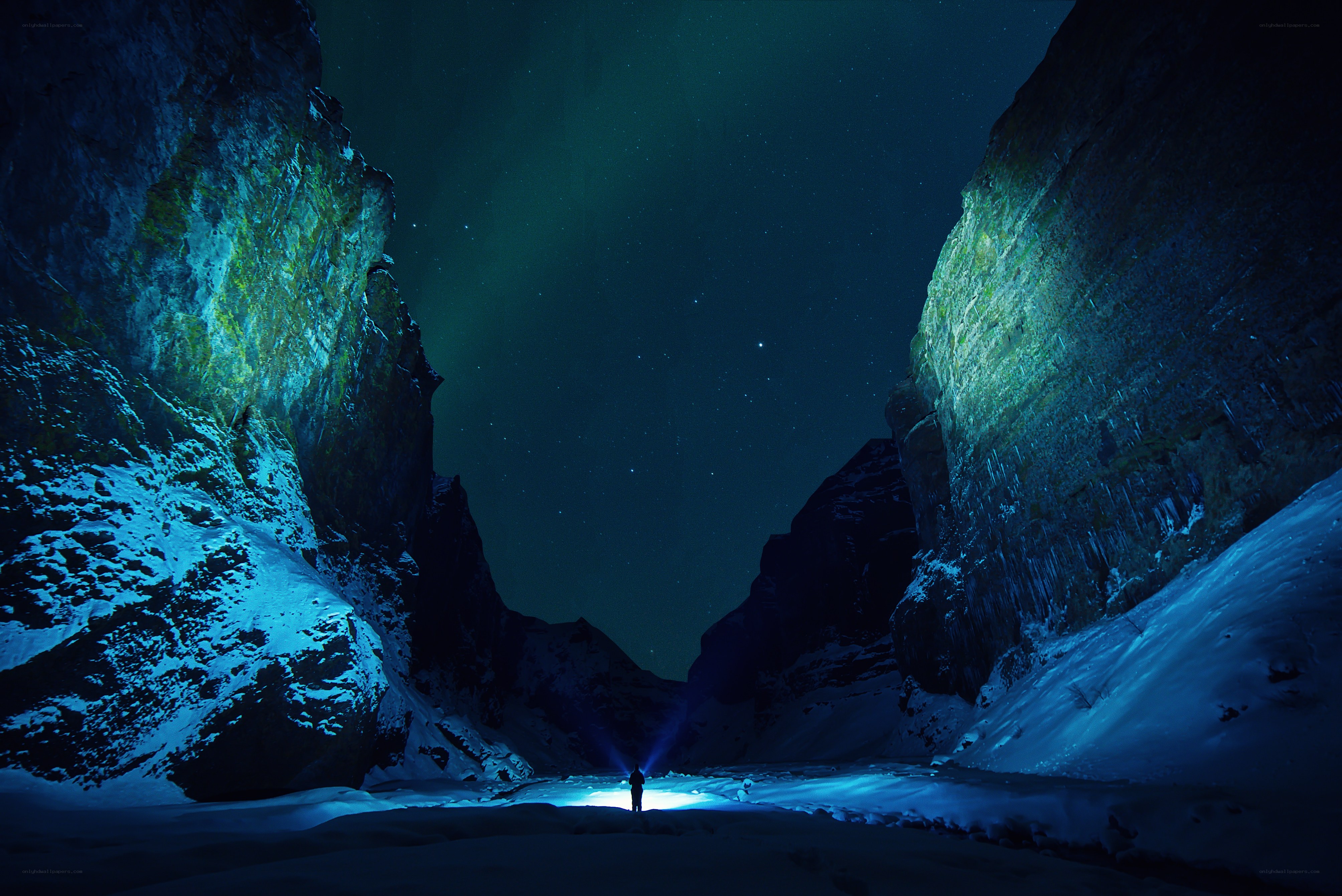Person in snowy canyon at night