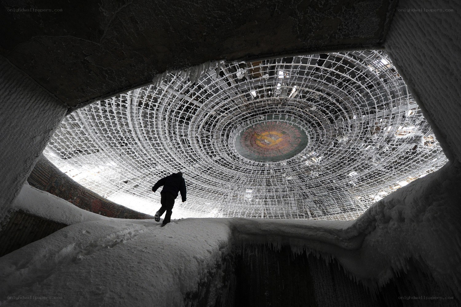 Person in snowy dome structure