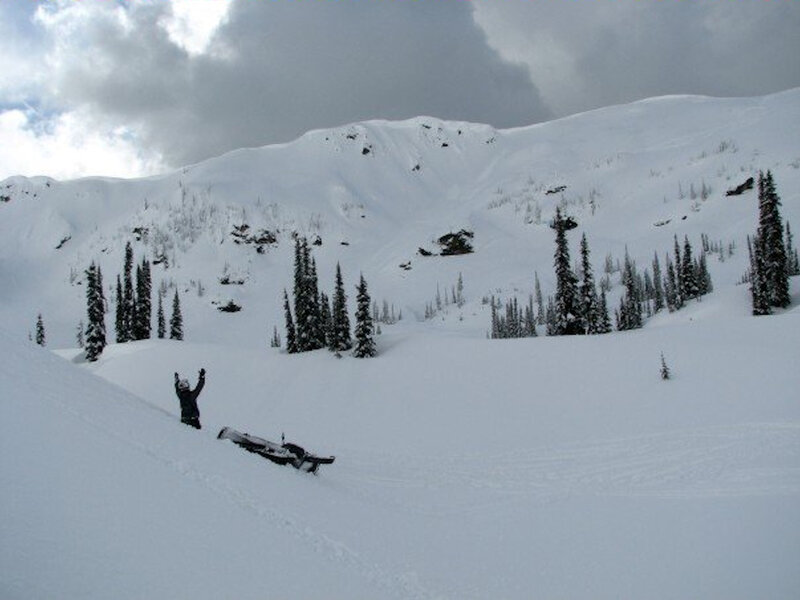 Person in snowy landscape with snowmobile