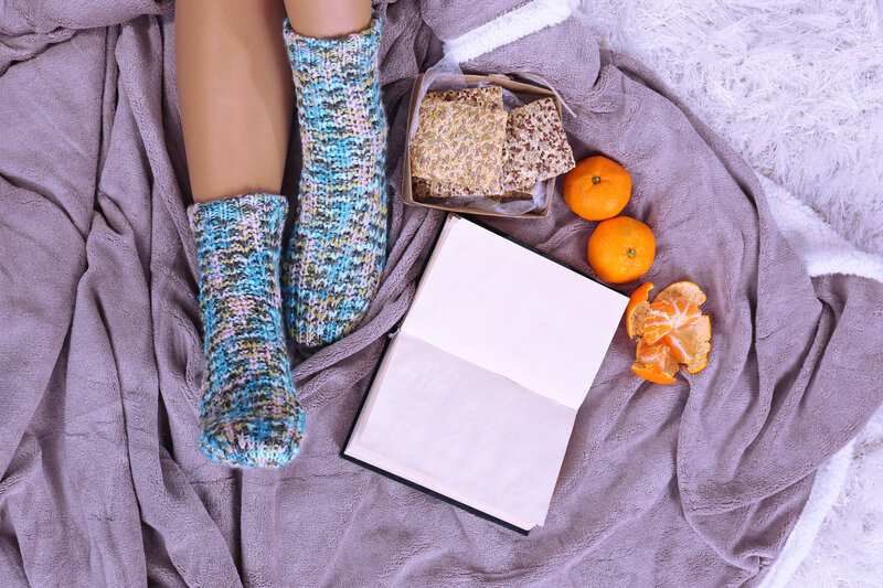 Person in Socks on Blanket