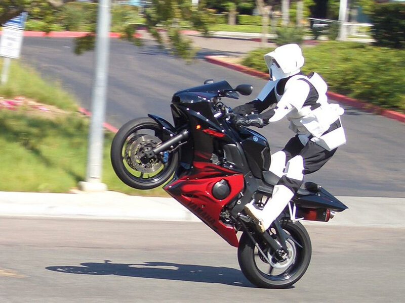 person in stormtrooper costume on motorcycle