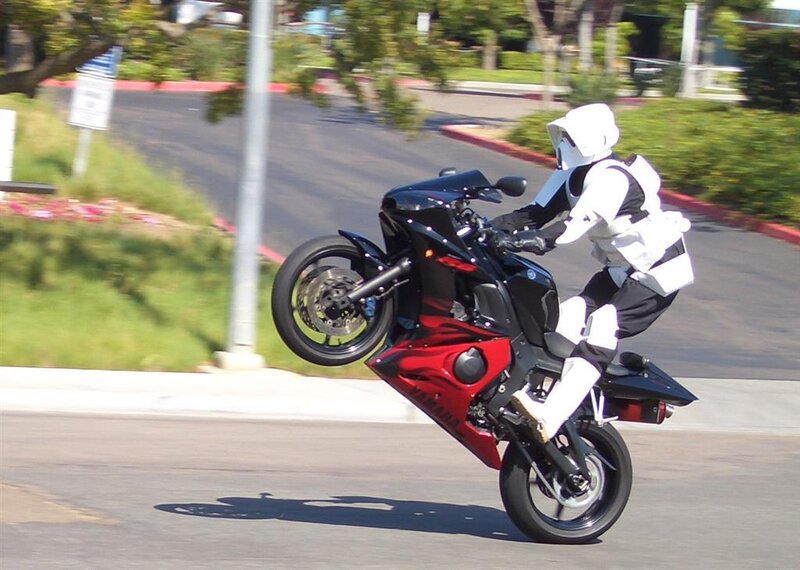 person in stormtrooper costume on motorcycle