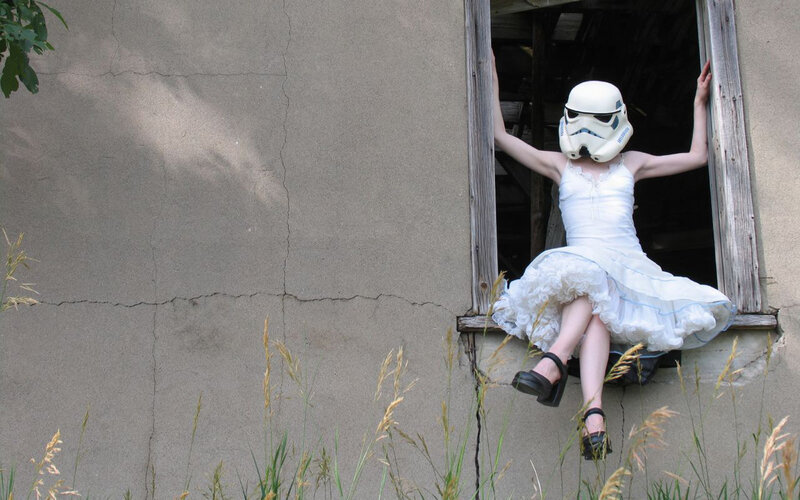 person in stormtrooper helmet at window