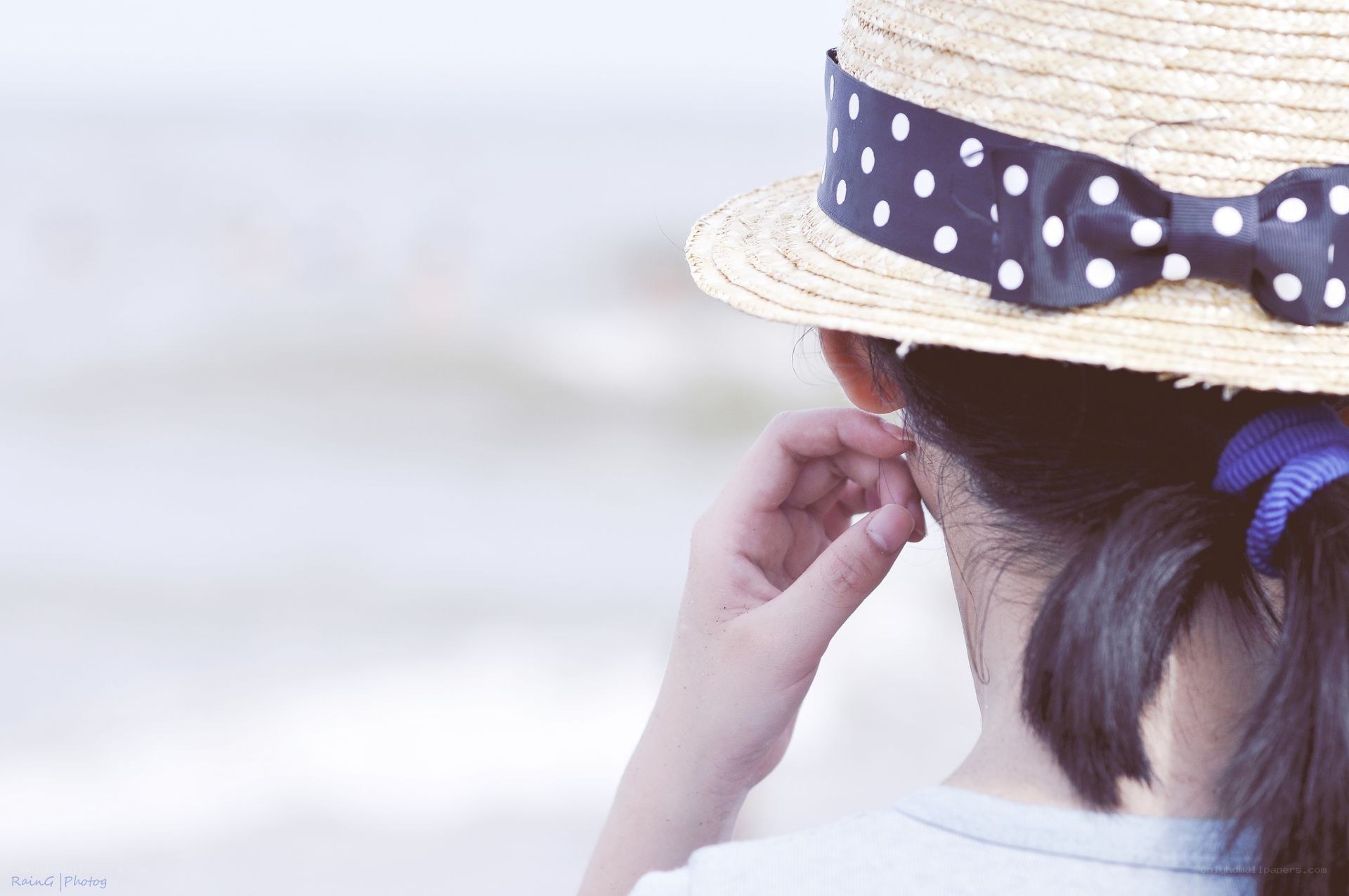 person in straw hat at beach