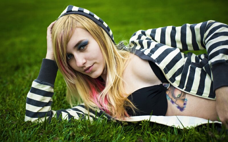 person in striped hoodie on grass