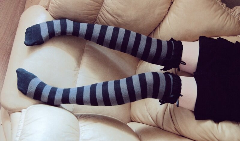person in striped socks on couch