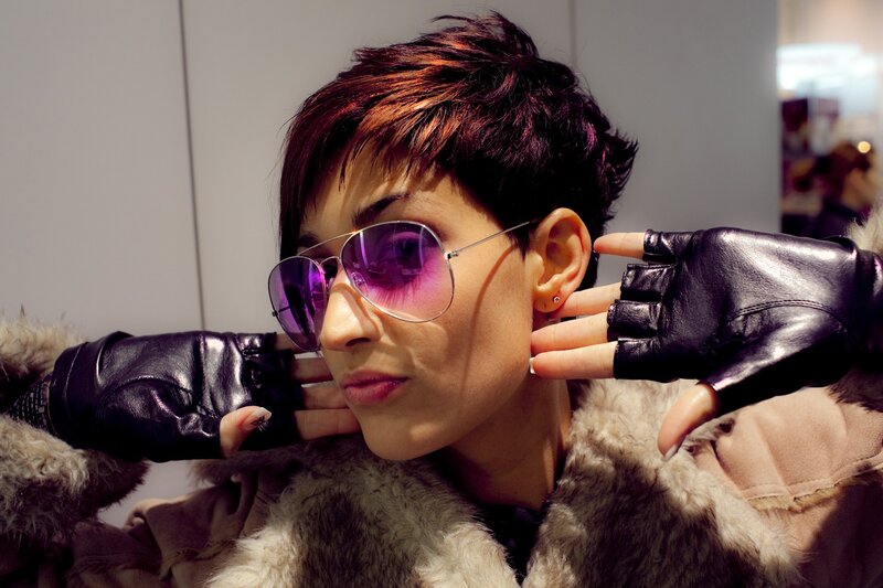 person in sunglasses and gloves