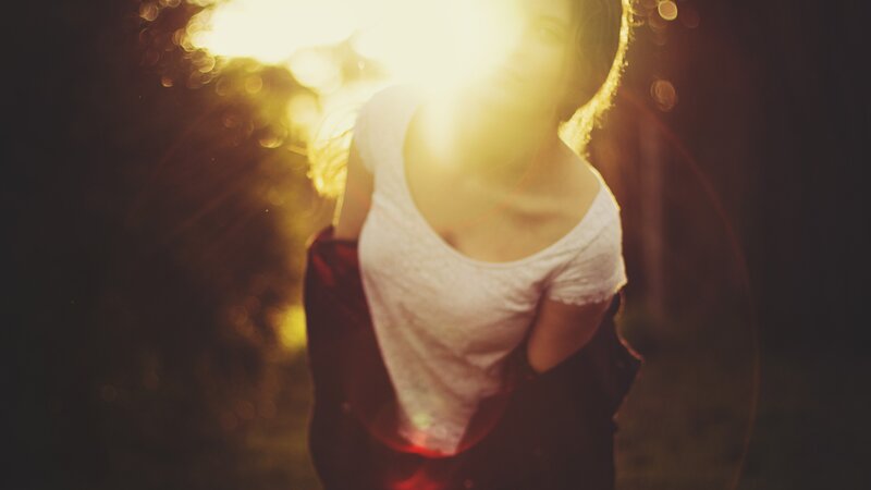 person in sunlight with lens flare