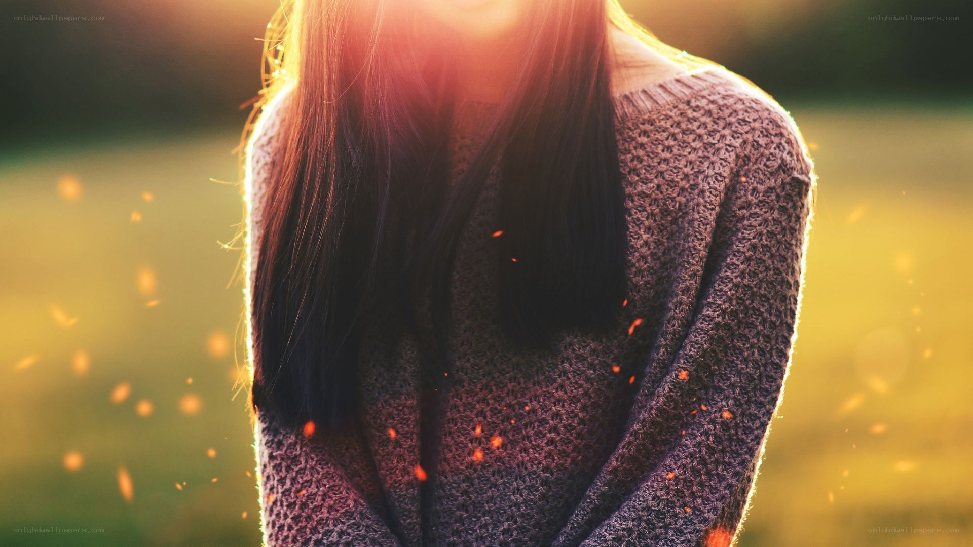 person in sweater at sunset