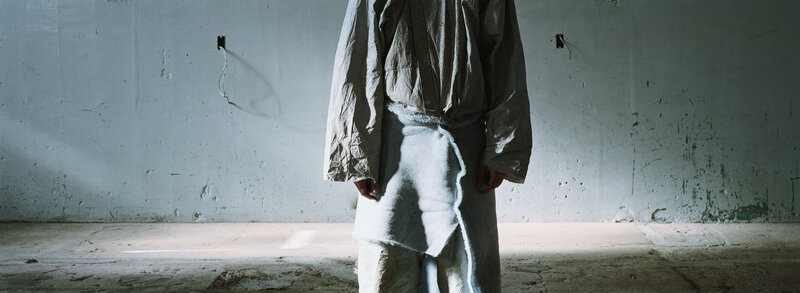 person in tattered clothes