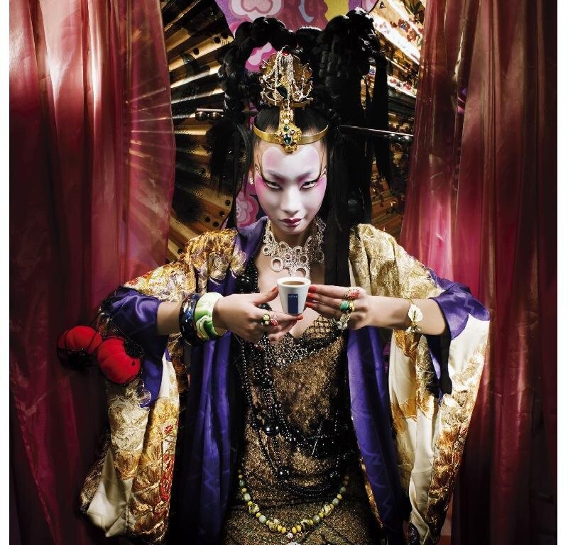 person in traditional costume holding cup