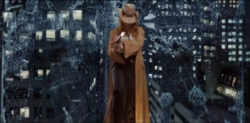person in trench coat with gun